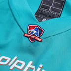 Product details of Custom Aqua Football Jersey showing stitched logos, fabric and customization options By Athletrio