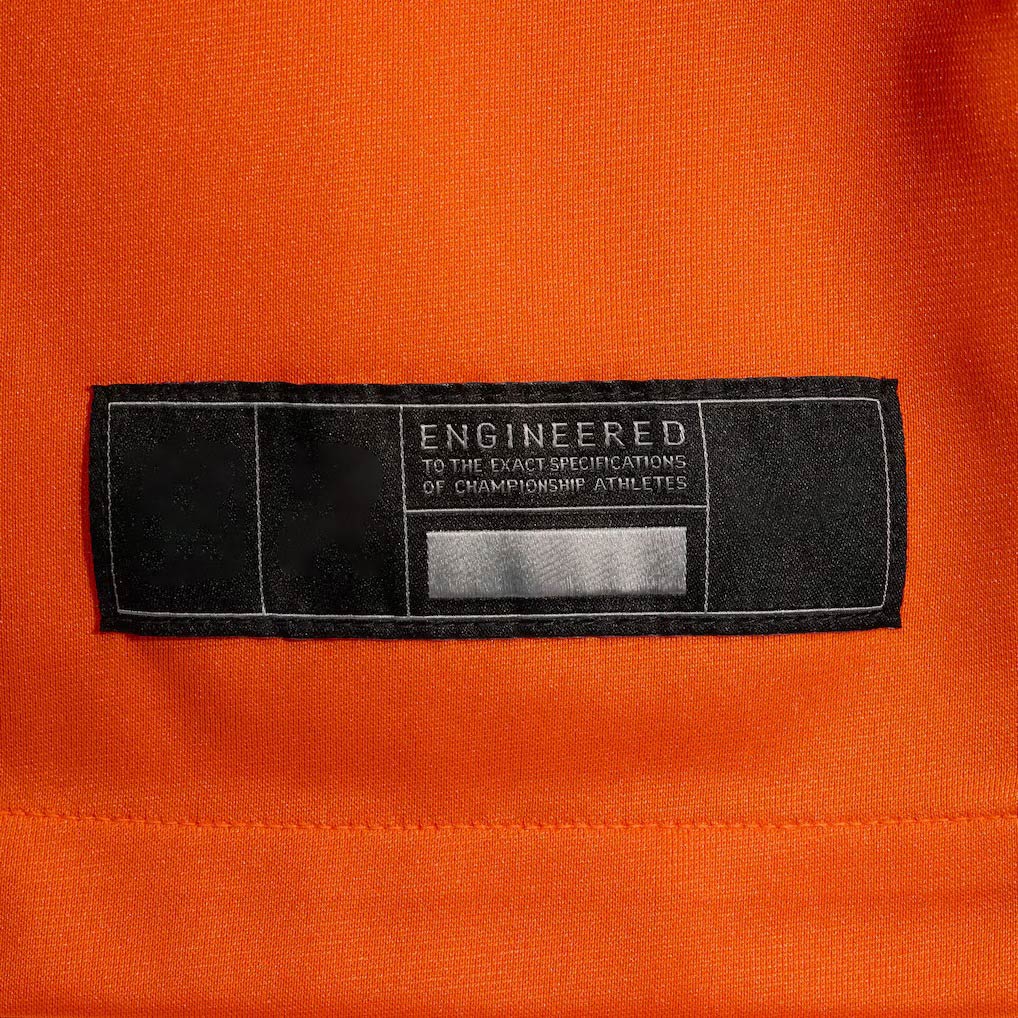 Product details tag of Custom Denver Orange Football Jersey showing stitched logos, fabric and customization options By Athletrio